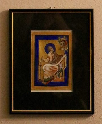 Saint Matthew writing down the gospel. Illuminated manuscript on parchment